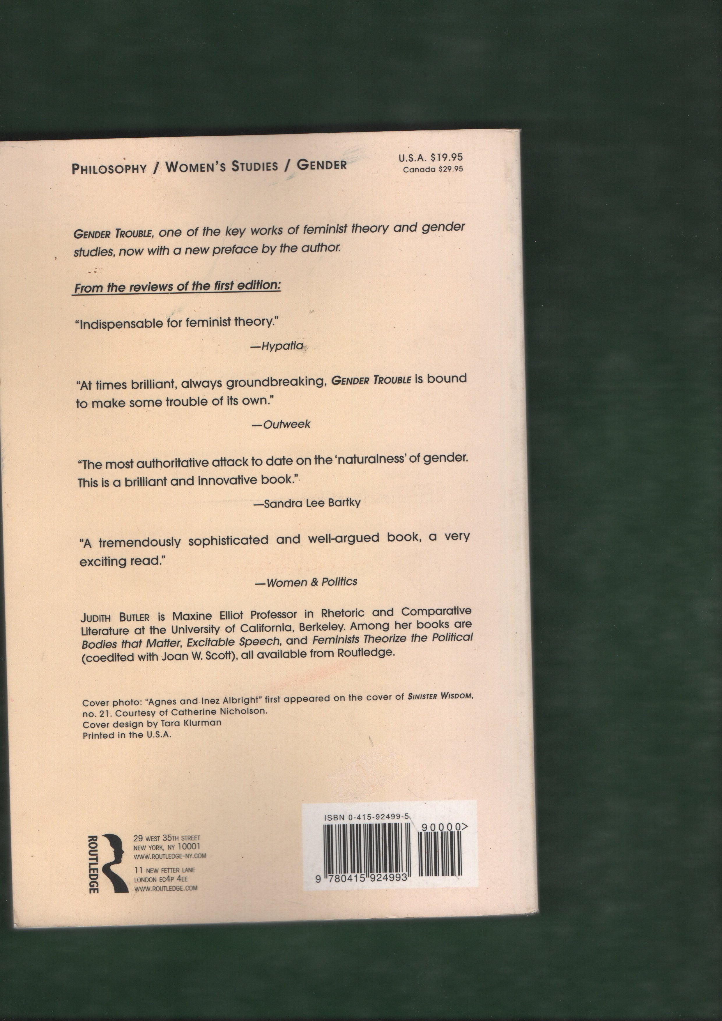 Back cover of a book with text and a barcode on a green background
