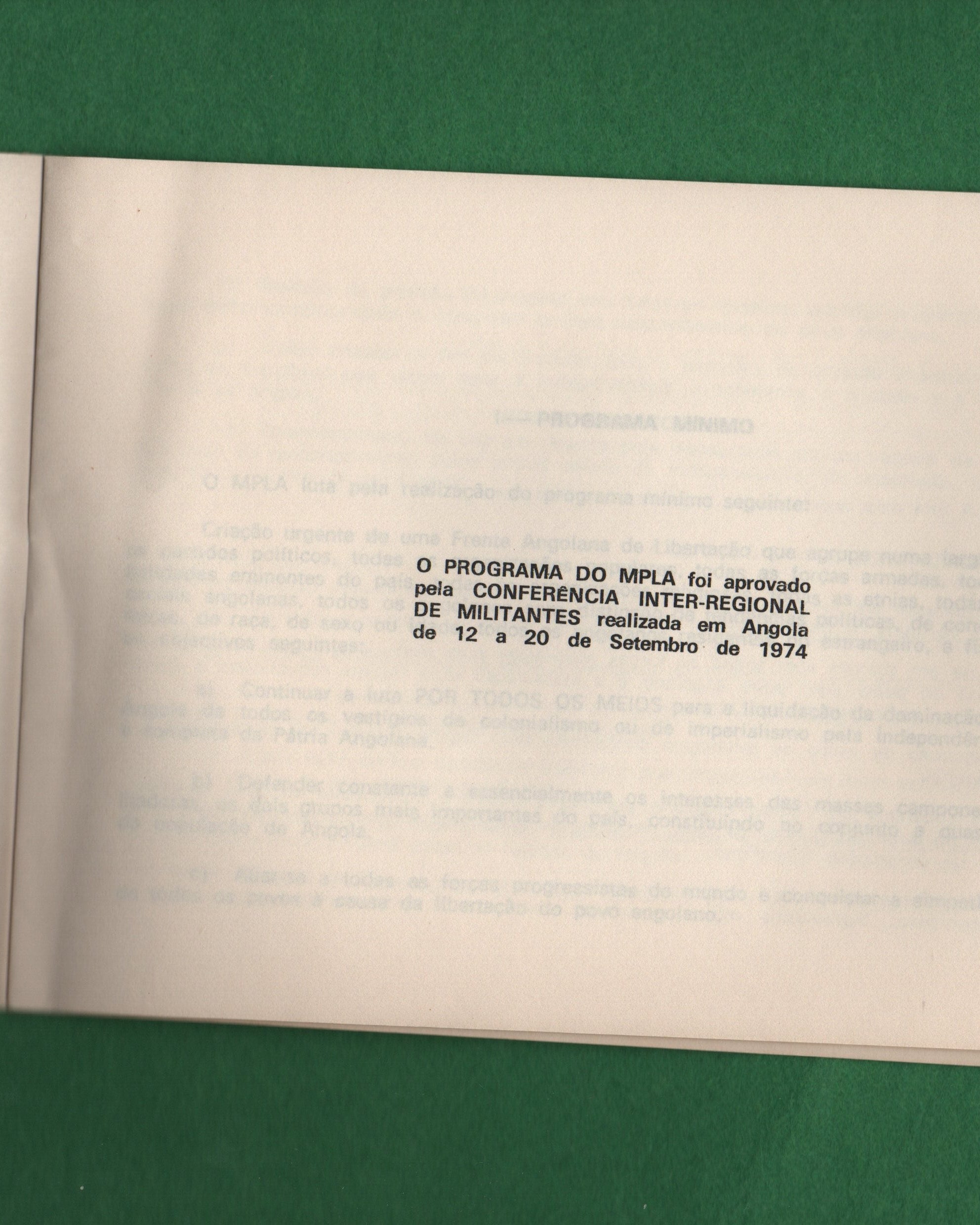 Open book with text on a green surface