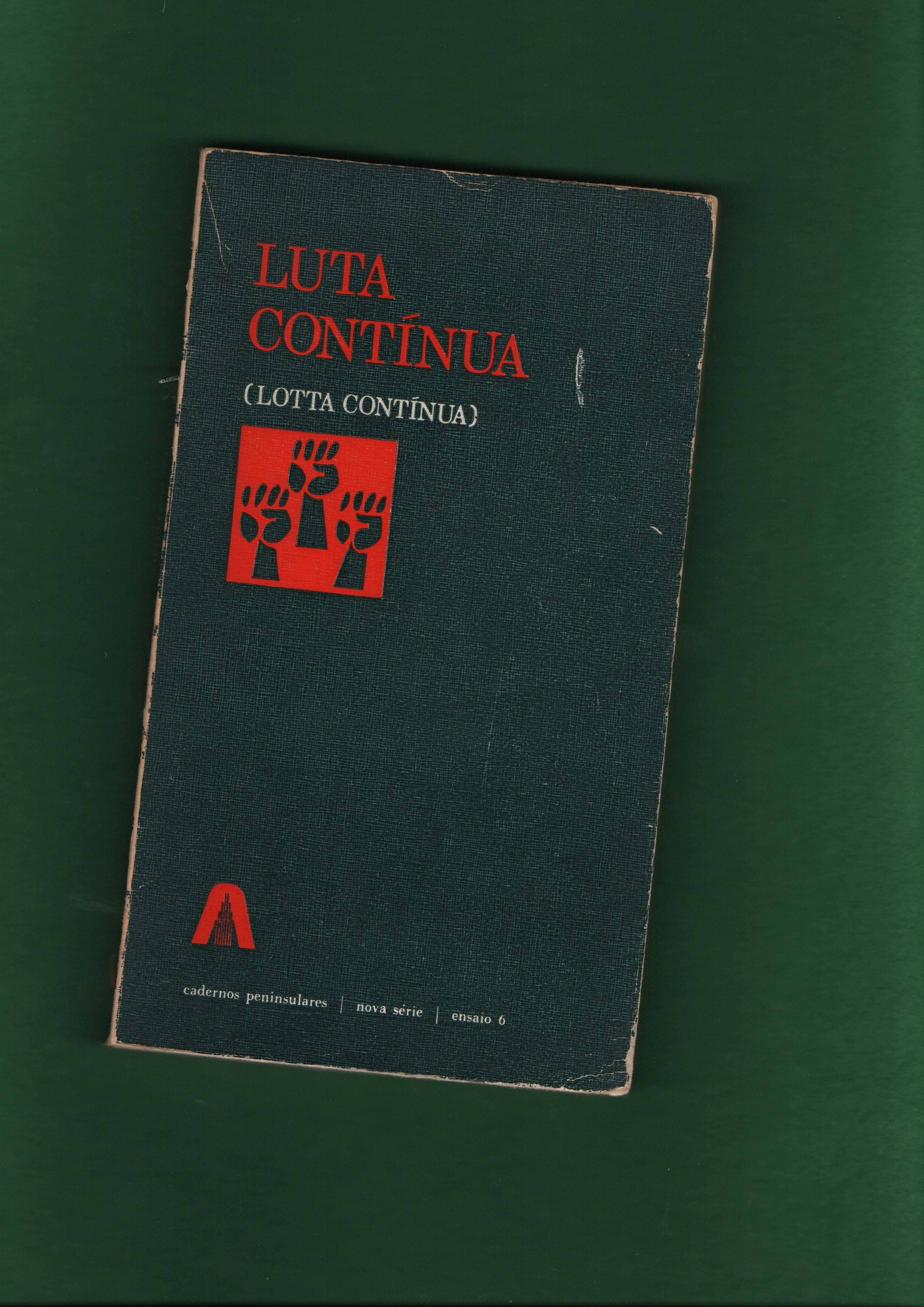 Book with a red square with three clenched fists and text on a green background